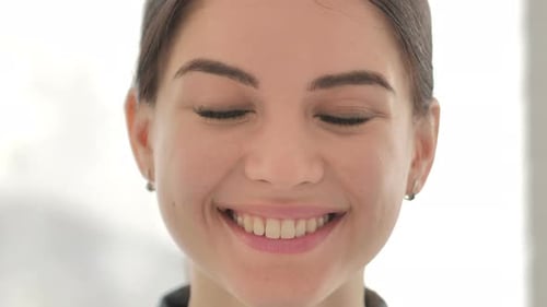 Woman Smiles Directly Into Camera in Close Up