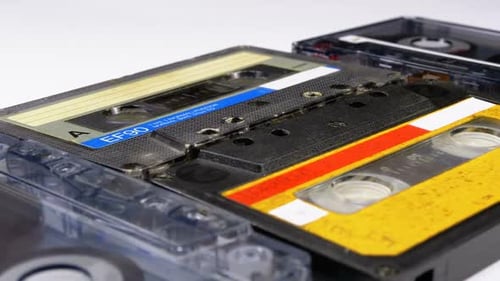 Four Audio Cassettes Rotate on White Background