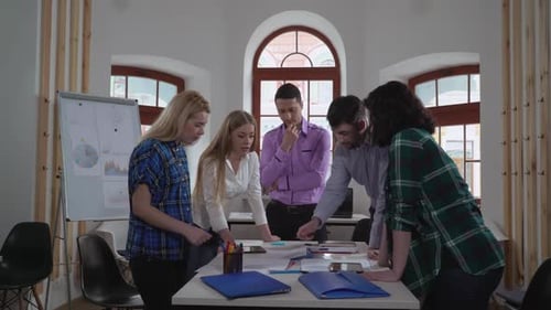 Team Discussing Business Strategy in Modern Office