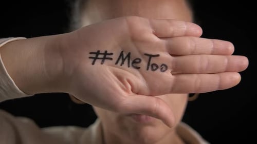 Woman Covers Face with #metoo Message on Hand