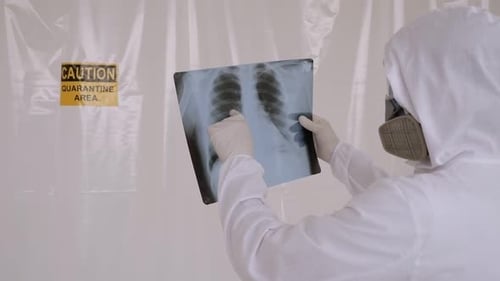 Portrait of a Doctor in a Medical Suit in a Hospital with an Xray in His Hands
