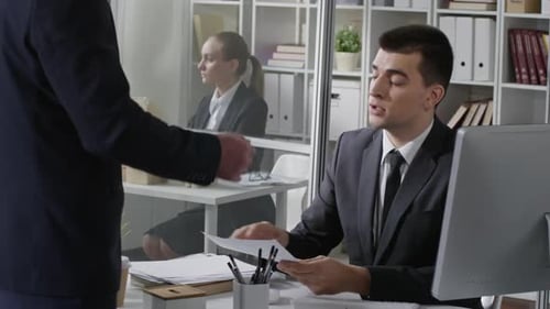 Business Meeting and Handshake at Office Desk