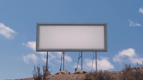 Billboard Against a Blue Sky with White Clouds Timelapse