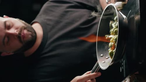 Vertical Video of Chef Frying Green Brussels Sprouts Cabbage in Pan Closeup
