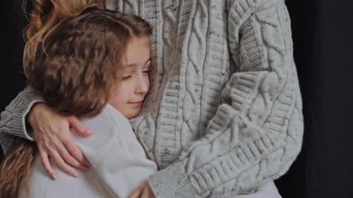 Girl Hugging an Adult Woman in Warm Embrace