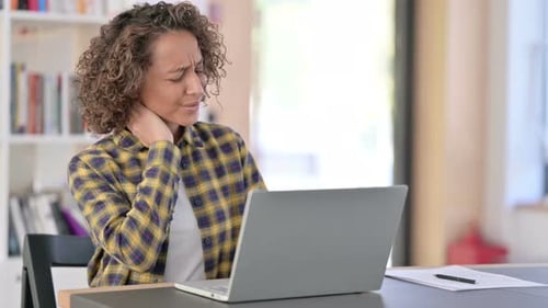 Woman Working on Laptop with Neck Pain
