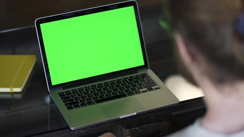 Laptop Green Screen Presentation in Modern Workplace Setting
