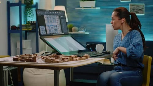 Engineer Analyzing Building Model and Maquette