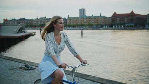 Young Blond Woman Riding Bicycle