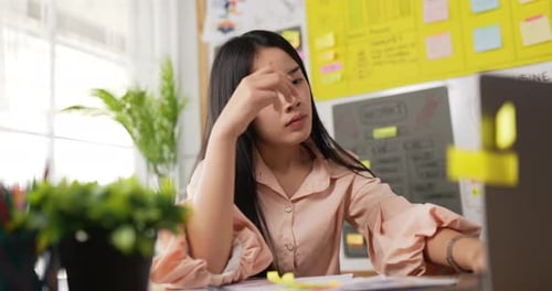 Young Woman Working at Laptop in Home Office