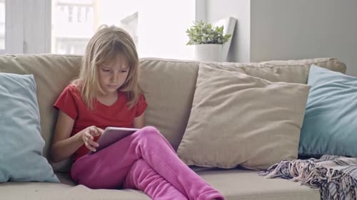 Little Girl Playing on Tablet