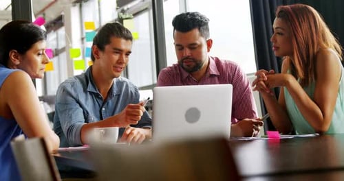 Team Working Together on a Laptop in an Office