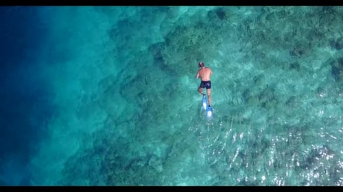 Two people posing on tranquil bay beach adventure by blue lagoon and white sand background of the Ma