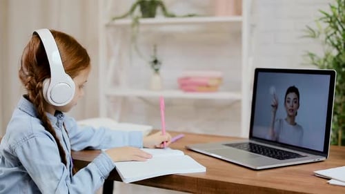 Girl Using Laptop to Learn Online at Home