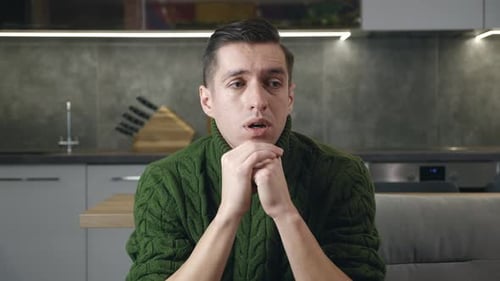 Man Overwhelmed with Sadness in Modern Kitchen