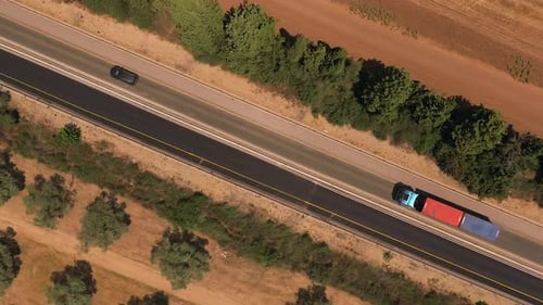 Super slow motion shot of a truck loaded with Shipping container on a rural highway.