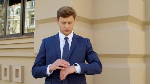 Closeup Businessman Waiting Outdoors. Guy Checking Time on Smart Watch at Street