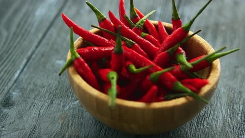 Red Chili Peppers in Bowl on Wooden Table