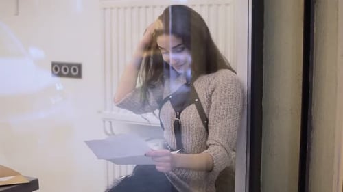 Young Woman Reading Letter Indoors at Home