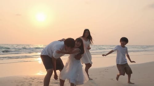 Asian Family playing together at beach with kids happy vacation travel beach concept