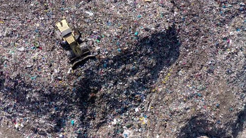 Aerial View of Massive Landfill with Bulldozer