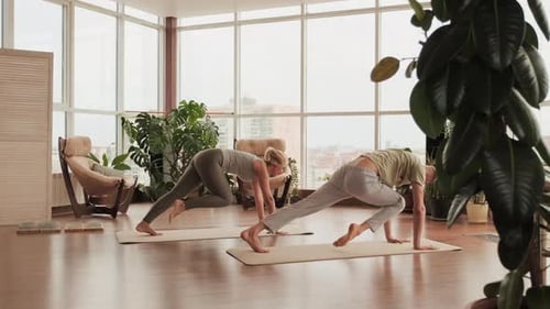 Couple Does Yoga in Modern Bright Home