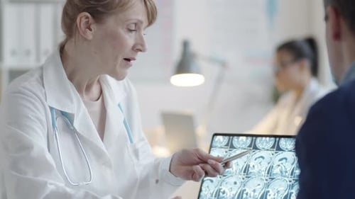 Doctor Explains Brain Scan to Patient in Office