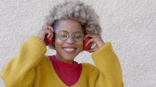 Smiling Woman Listening to Music on Headphones