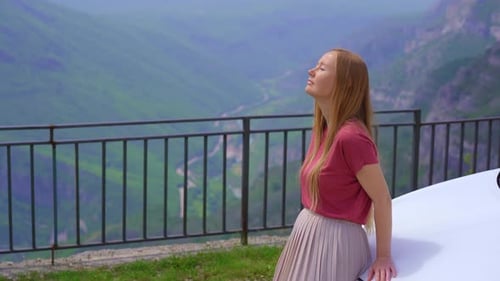 A Young Woman is Relaxing Standing By a Car at a Viewpoint on a Beautiful Canyon of the Cijevna