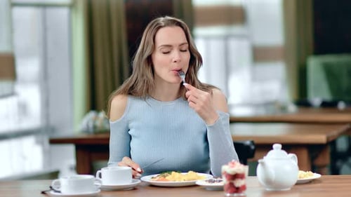 Portrait of Smiling Woman Eating Fresh Tasty Food Posing at Cafe Table