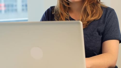 Woman working on laptop in modern office