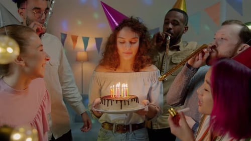 Friends Celebrate Birthday with Cake and Noise Makers