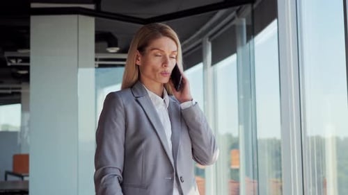 Woman Talking on Phone in Modern Office