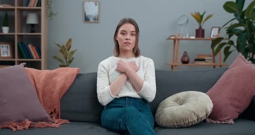 Woman on Couch Uses Sign Language
