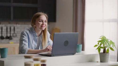 Woman on Video Call Using Laptop at Home