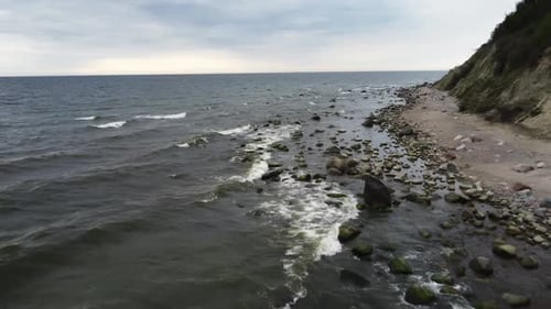 Sea with Waves at Windy Cold Day and Rock with Stones are Filmed By Drone