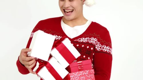 Man with Christmas Presents in Festive Sweater and Hat