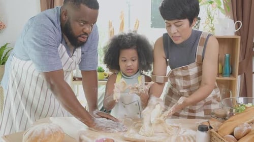Family Baking Bread Together in Home Kitchen