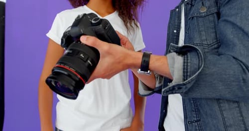 Girl and Adult Look at Camera Screen Together