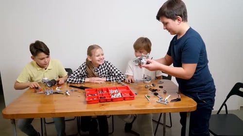 Happy Kids Helping Boy Create Toy