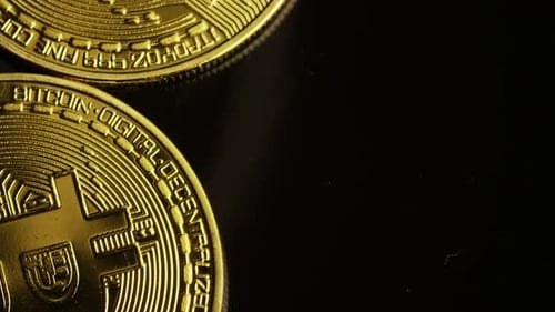 Rotating shot of Bitcoins (digital cryptocurrency) - BITCOIN