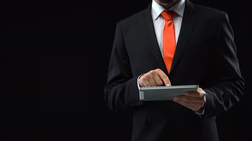 Man in Suit Using Tablet Technology