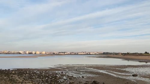 Coastal Cityscape Reflection on Tidal Flat
