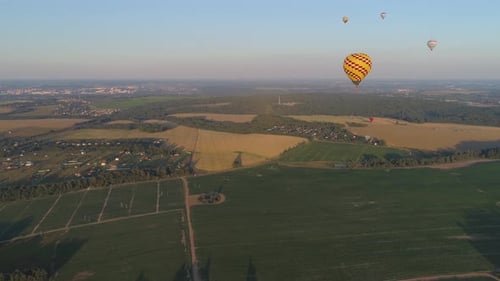 Aerial View of Hot Air Balloons Over Rural Landscape