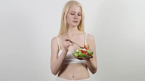 Slender Woman Enjoys a Fresh Vegetable Salad