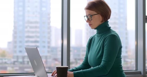 Business woman works in a modern office for a laptop
