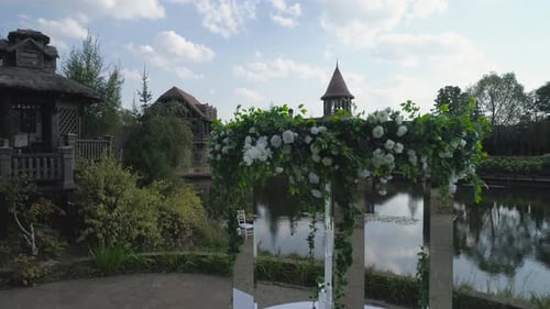 Elegant Outdoor Wedding Venue Setup with Floral Arch