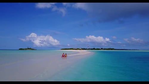 Young couple happy together on tranquil sea view beach break by turquoise sea with white sandy backg