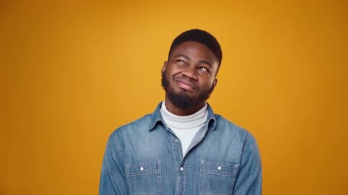 Man Making Faces on Yellow Background