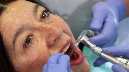 Dentist Polishes Client's Upper Teeth